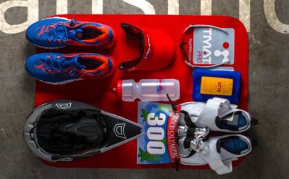 A selection of essential gear for triathlon, running, and cycling, including shoes, helmets