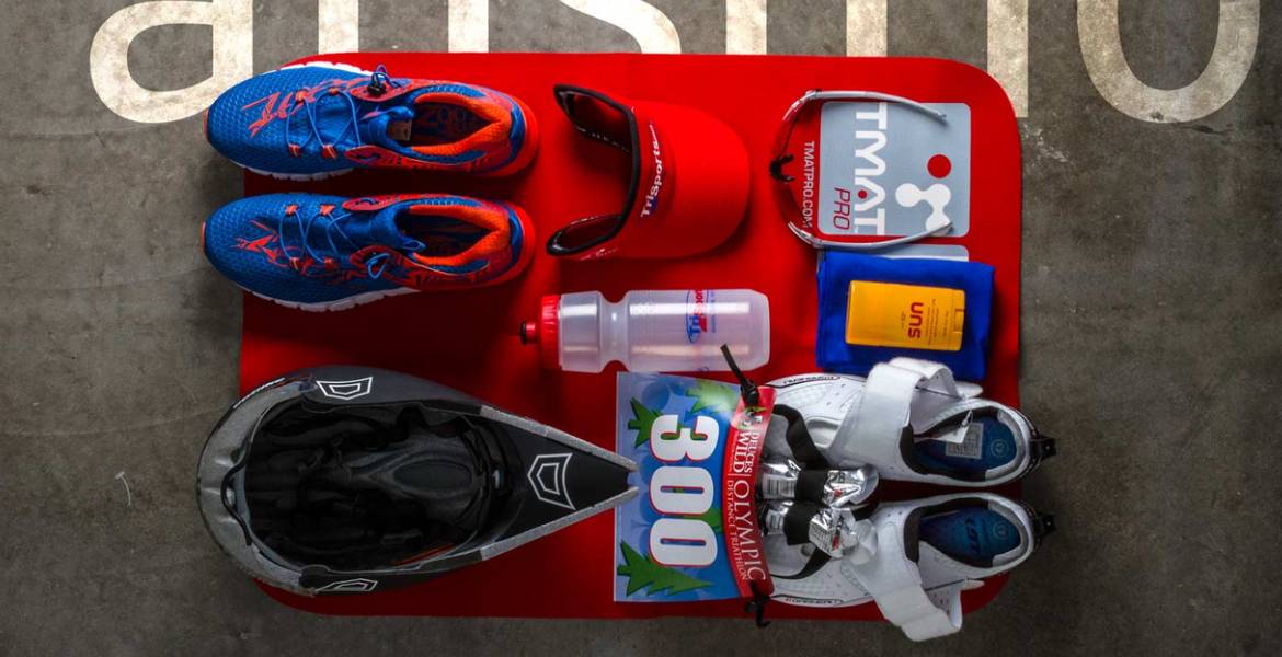 A selection of essential gear for triathlon, running, and cycling, including shoes, helmets