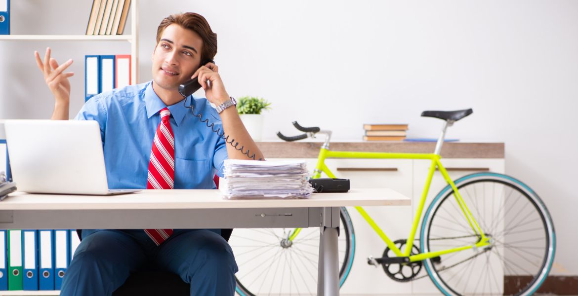 A person juggling work, family, and triathlon training with a triathlon bike in the background.