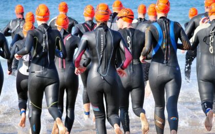 Triathletes swimming in an ironman event.